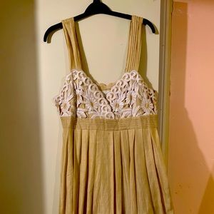 Beige sundress with cream appliqué. Gently used.
